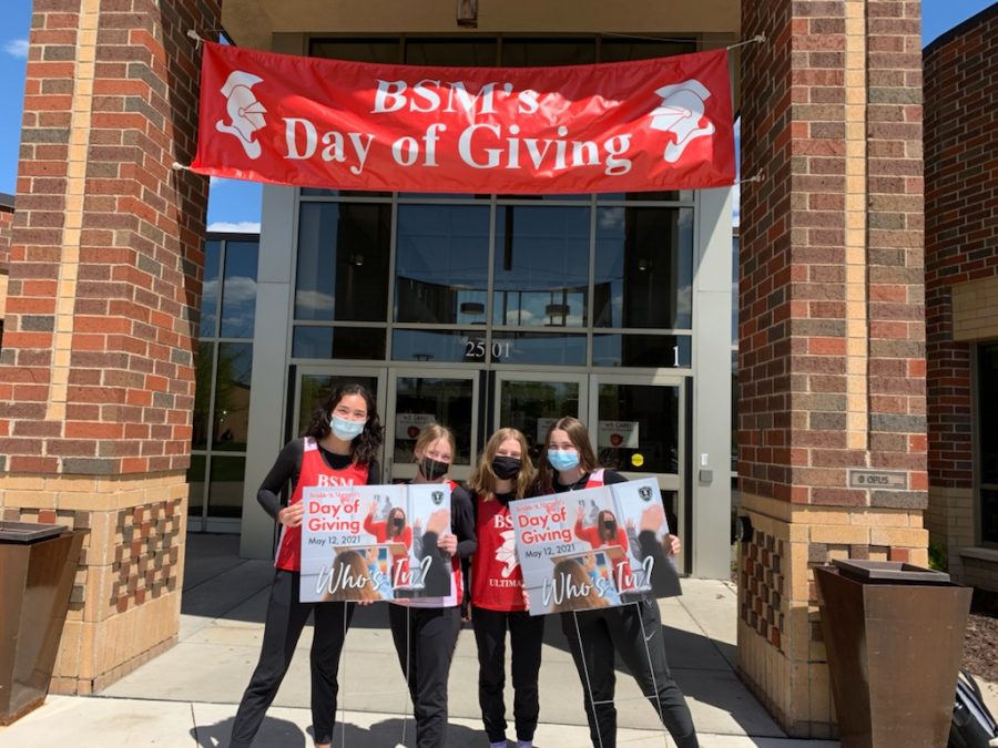 Students stand outside BSMs main doors to celebrate todays Day of Giving.