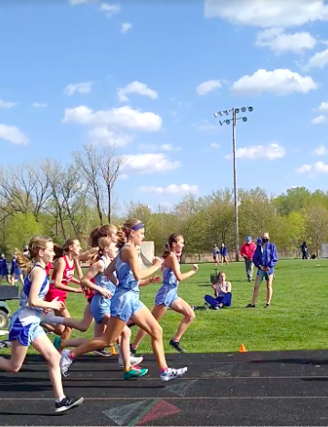 Girls' track runners compete maskless in the spring 2021 season. 