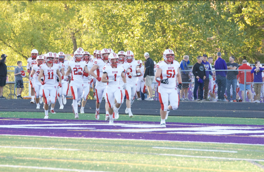 Red Knights storm onto the field to take on the Chaska Hawks.