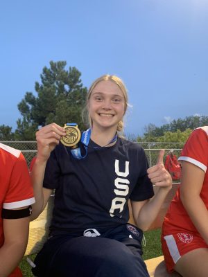 Dual-sport athlete Olivia shares her USA Basketball gold medal with her soccer teammates after returning from Mexico.