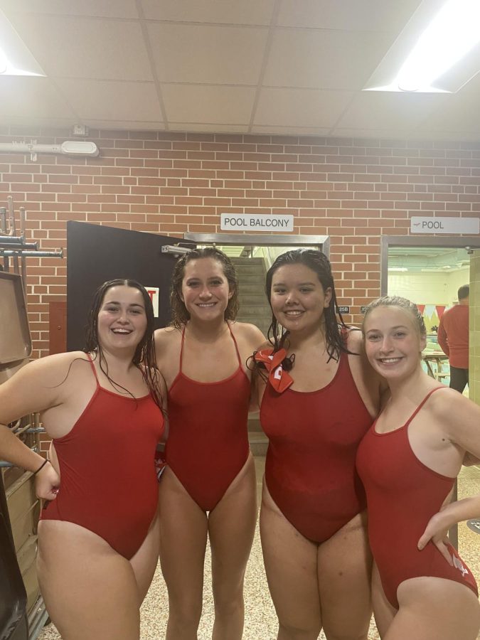 Senior swimmers celebrate after completing their relay in Tuesday night's swim meet.