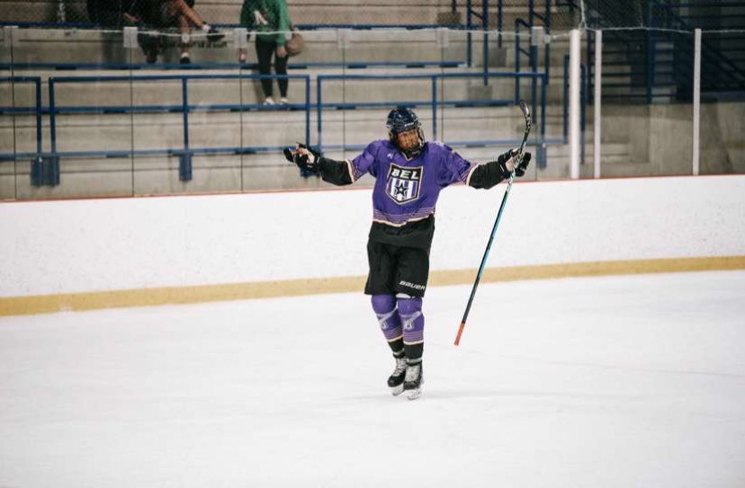 Phillips celebrating on the ice after a goal in a BEL game.