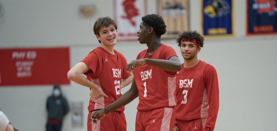 Seniors Sam Best, Daniel Ijadimbola, and Camden Carter celebrate after a win