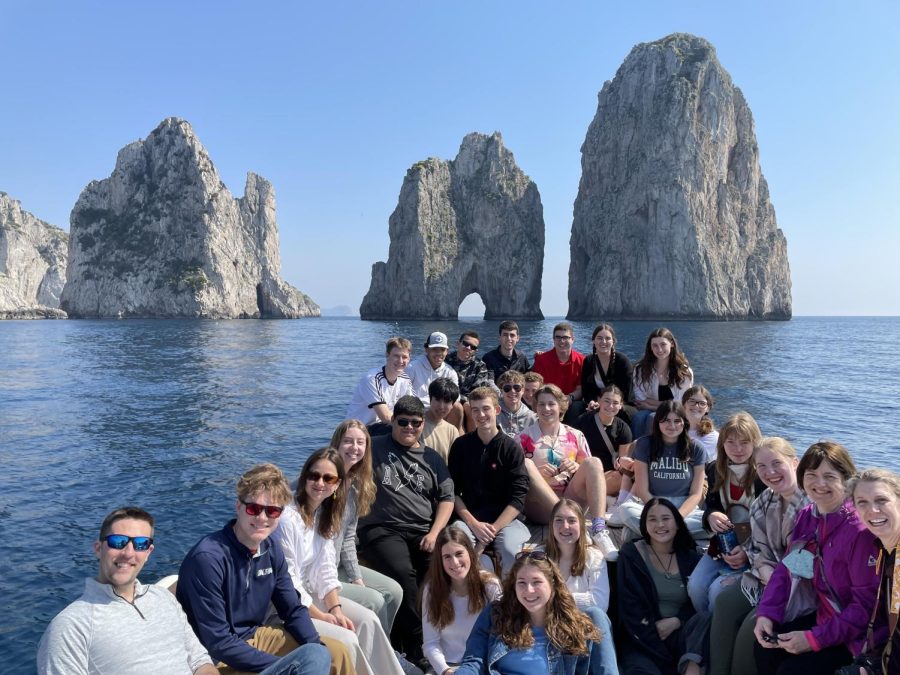 The group of BSM travelers on the boat in front of Capris famous rocks in the Mediterranean Sea.