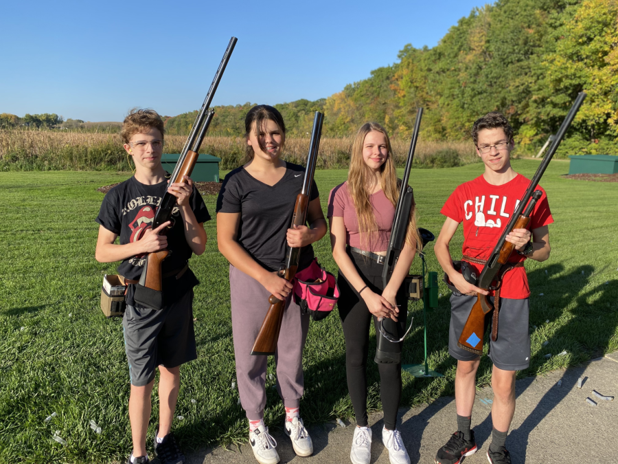 From left to right are James Ehmiller (9th grader), Ruby Wohlberg (11th grader), McKenzie Ehmiller (11th grader), and Jonah Vroman (9th grader) waiting to start clay target for the day.