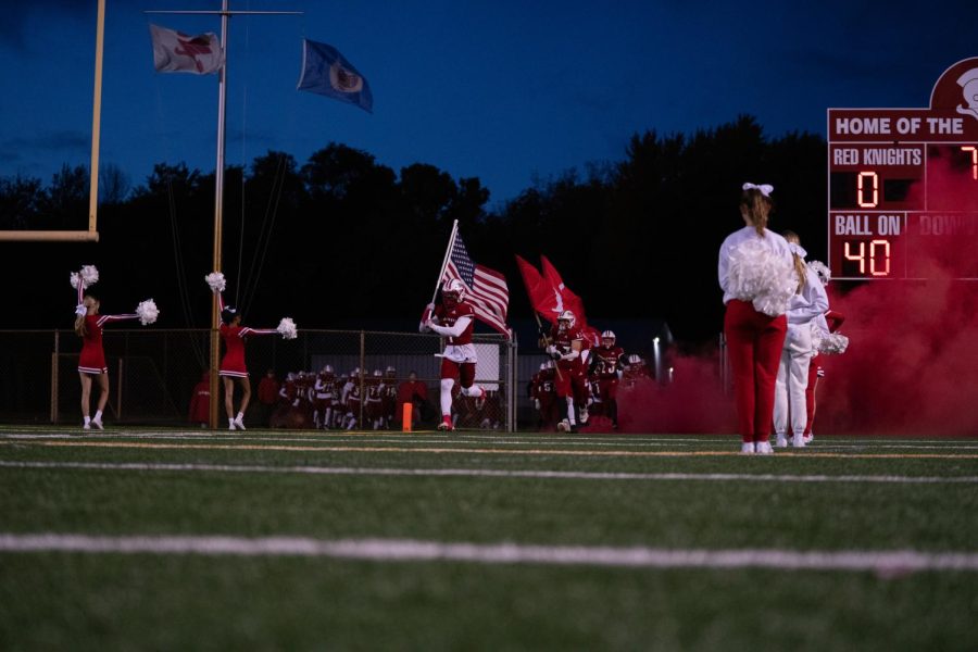 BSM+football+rushed+the+field+at+the+beginning+of+the+game+with+the+cheer+team+surrounding+them.