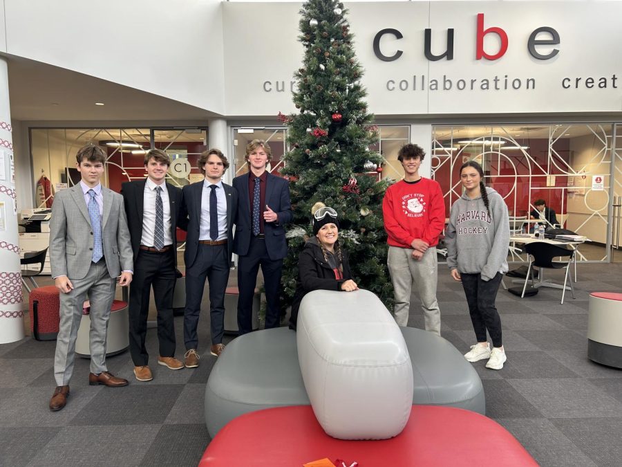 Students and staff getting into the Christmas spirit by admiring the tree in the Cube.