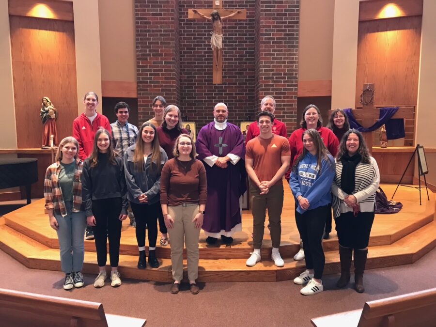 Students+and+faculty+standing+with+Father+Luke+Marquard+after+a+Lenten+mass+that+was+hosted+by+Senior+Eucharistic+Ministers.