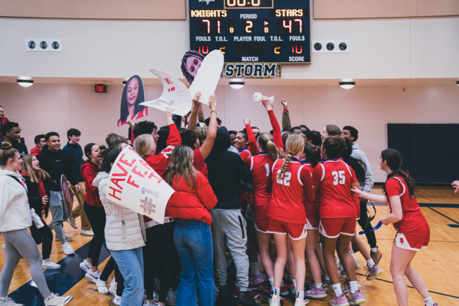 The girls basketball team celebrated their section win with the fans at the game.