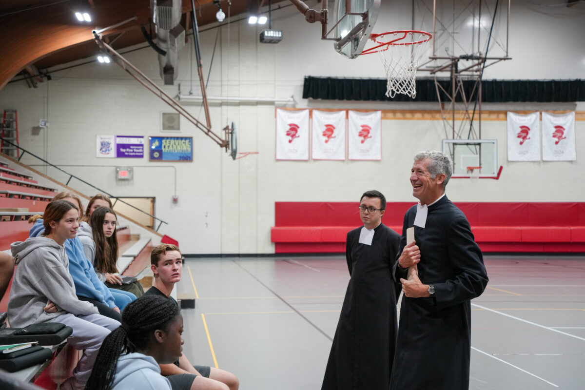 Christian Brothers Schatz and Hernandez-Bernal visit with students to explain discernment and a retreat opportunity.