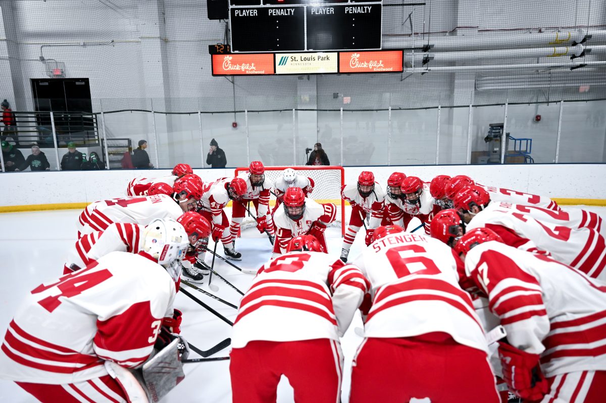 The BSM Boys Hockey team huddles in prayer before their game.