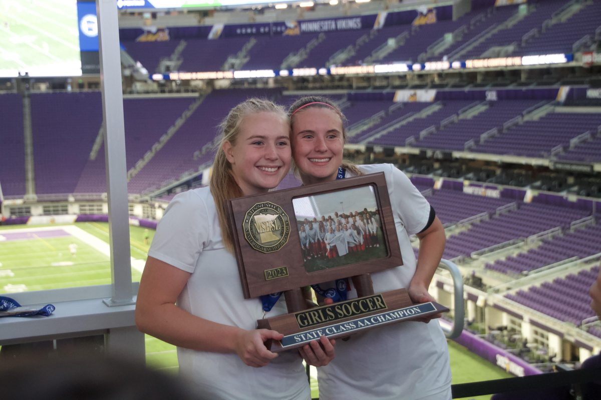 Brooke and Lauren Hillins taking a picture after winning state together.
