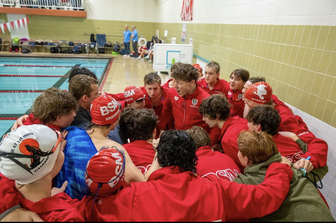 BSM Boys Swim team celebrates after a record-breaking performance in sections, qualifying them for state.