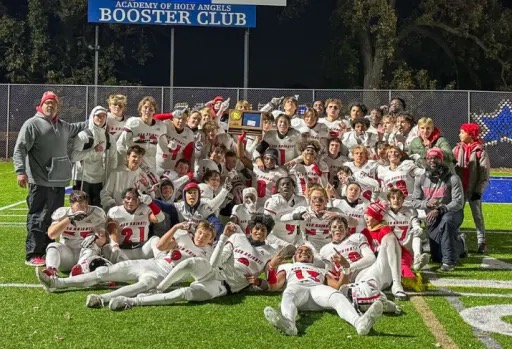 BSM Football team celebrates a win against Holy Angels that sent them to state.