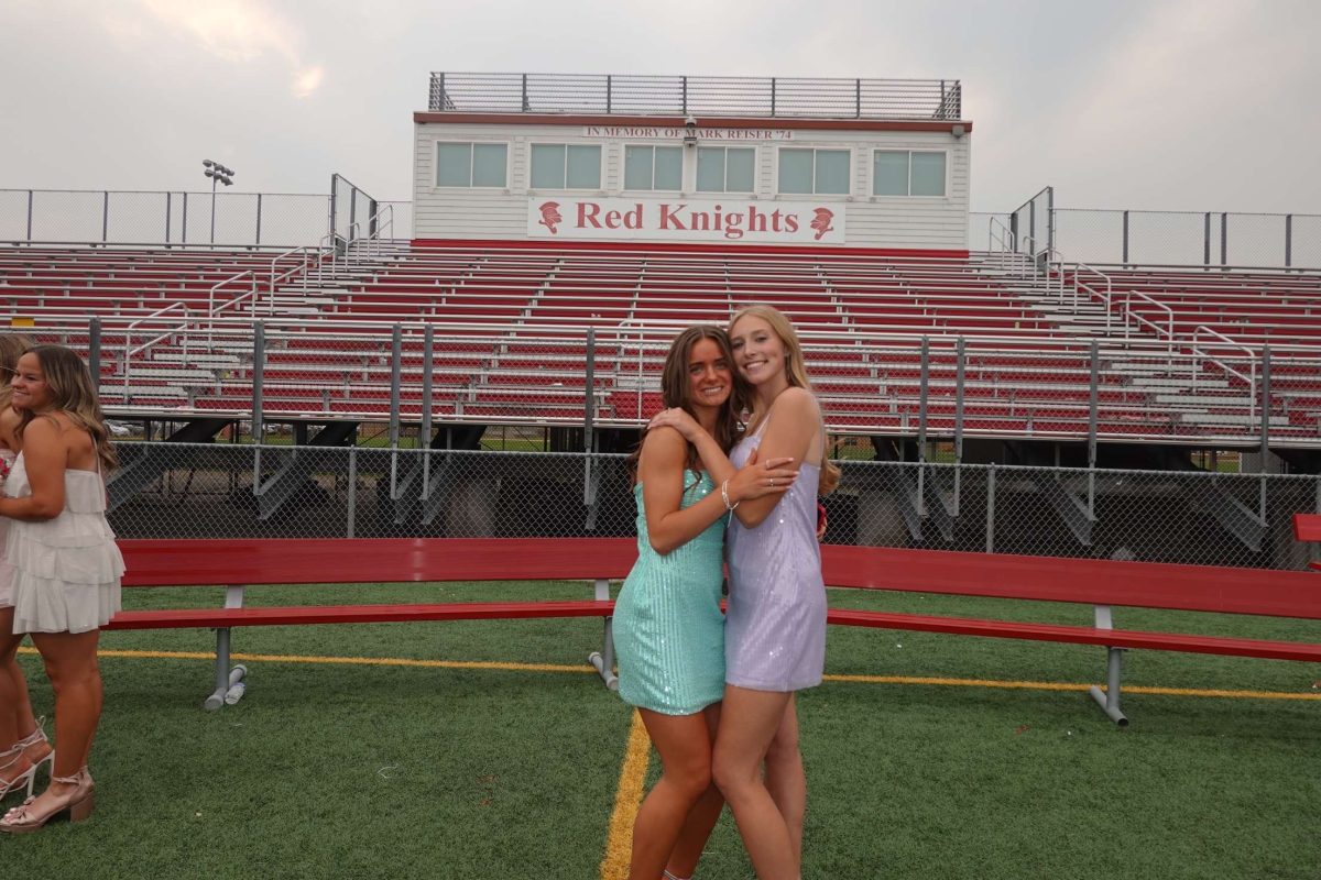 Senior Bridget Wickner at Benilde-St. Margaret's Homecoming taking photos with her friend, Lori Weltzin.