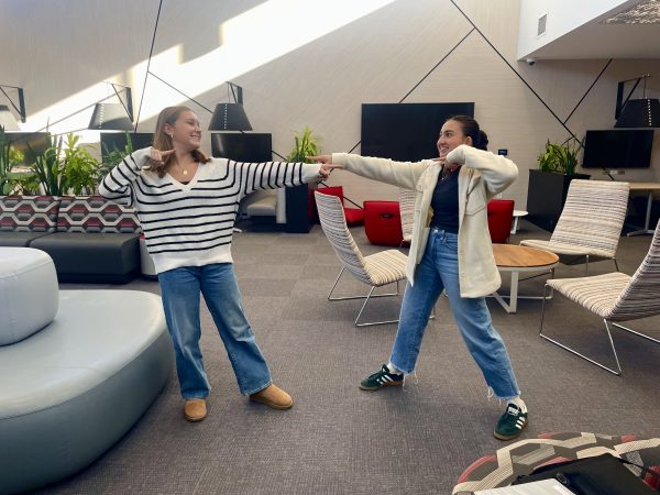 In the Cube, Sophomore Mary Waters and Senior Scarlett Lira show off their fall fashion in sweaters, wide leg jeans, Uggs, and Adidas shoes. 