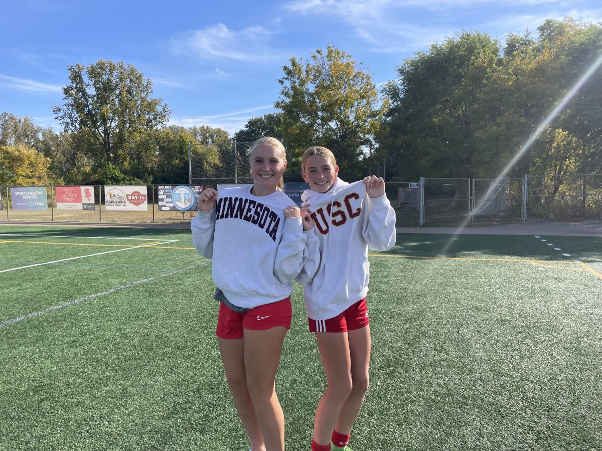 Warming up at soccer practice, Brooke and Claire pose in sweatshirts from Big Ten schools.