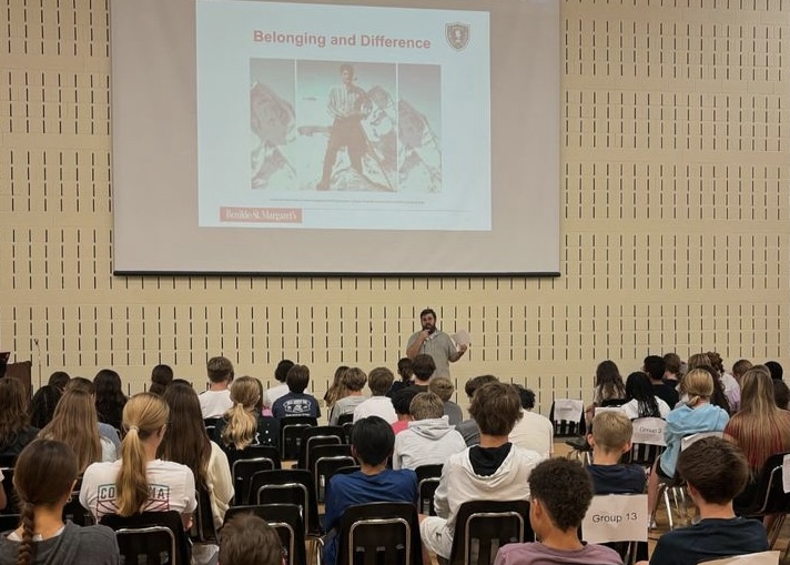 Freshman at their annual retreat listening to a presentation.