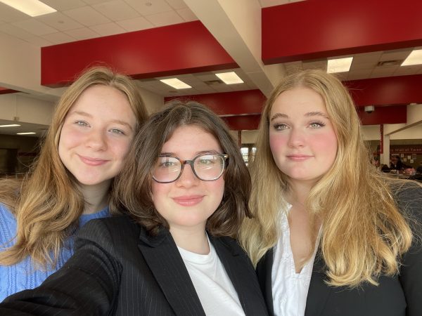 Three members of BSM debate team smile for the camera right before a big competition. 