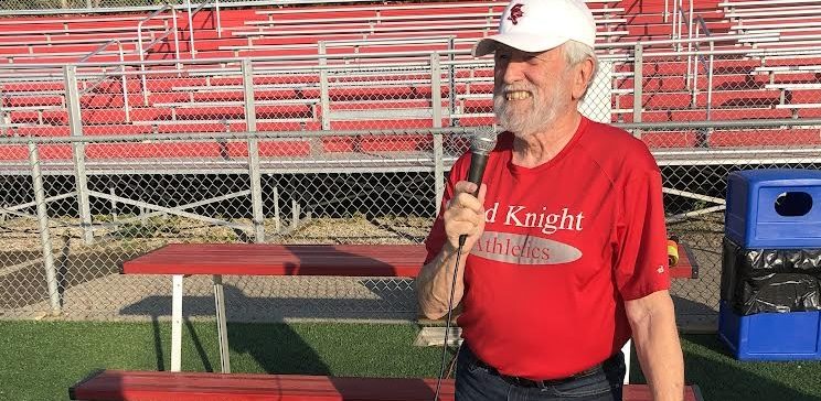 Mick Hawkins announcing at a sport game cheering on the Red Knights to victory.