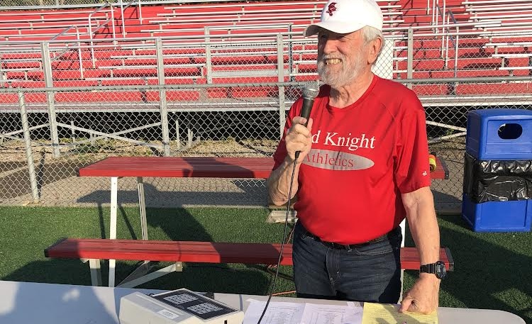 Mick Hawkins announcing at a sport game cheering on the Red Knights to victory.