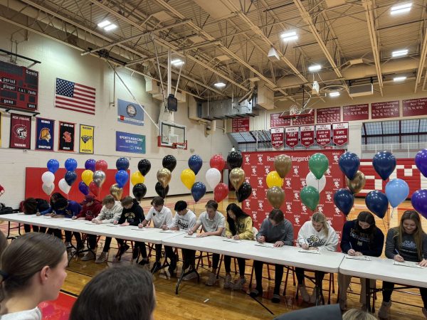 Student-athletes are recognized at morning ceremony as they officially sign with their college. 