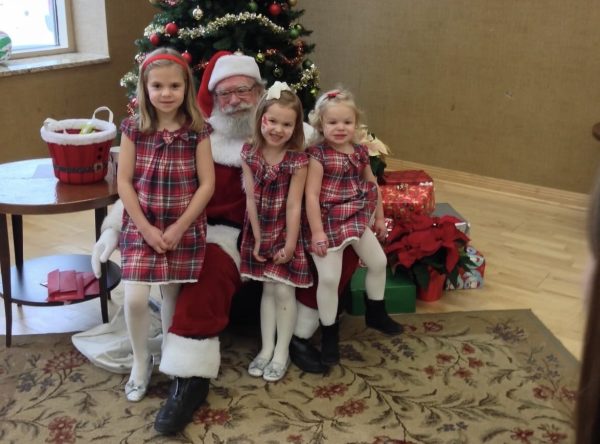 Senior Hannah Buller and her two sisters visiting Santa Clause over Christmas break 10 years ago. 