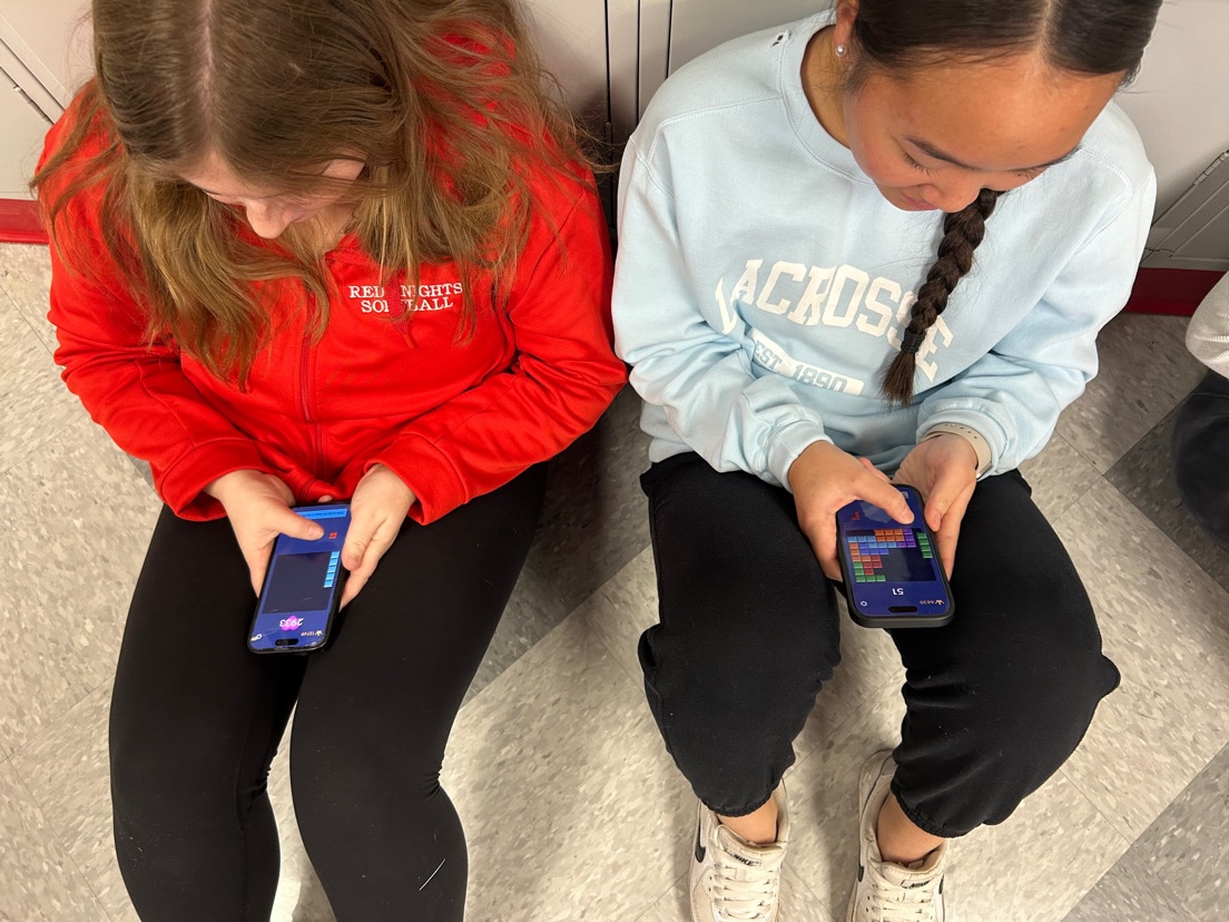 Students caught in the hallway, playing Block Blast instead of doing class work.