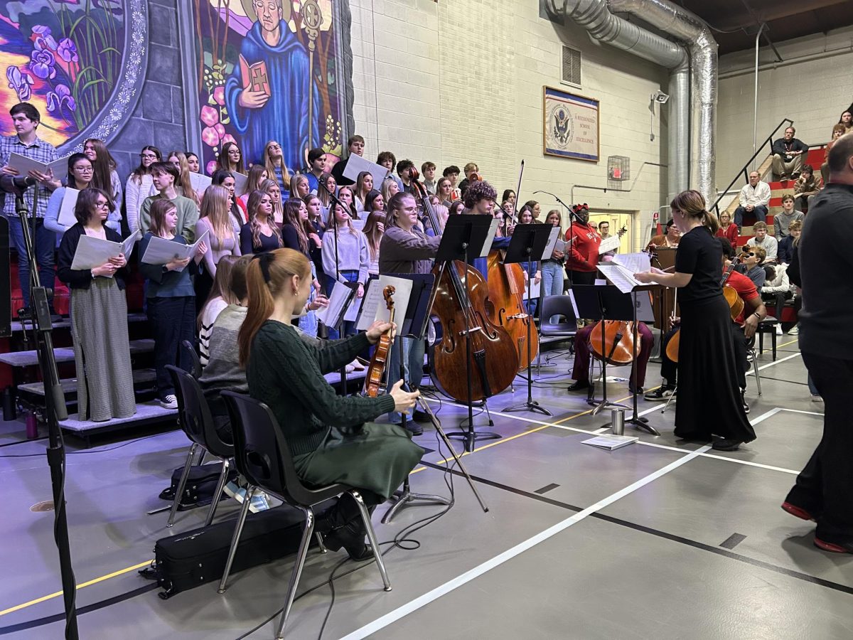 Sarah Foster, the new orchestra director, conducted the orchestra as they played at Mass for the first time since the 23-24 school year.