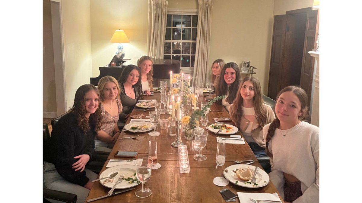 Sophomore Addy Brown and friends sitting down and celebrating a fun and festive Friendsgiving!