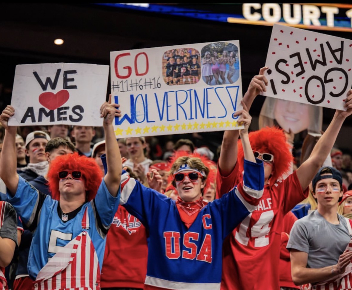Senior boys are SUPER FANS, cheering on the girls' volleyball in the state championship.