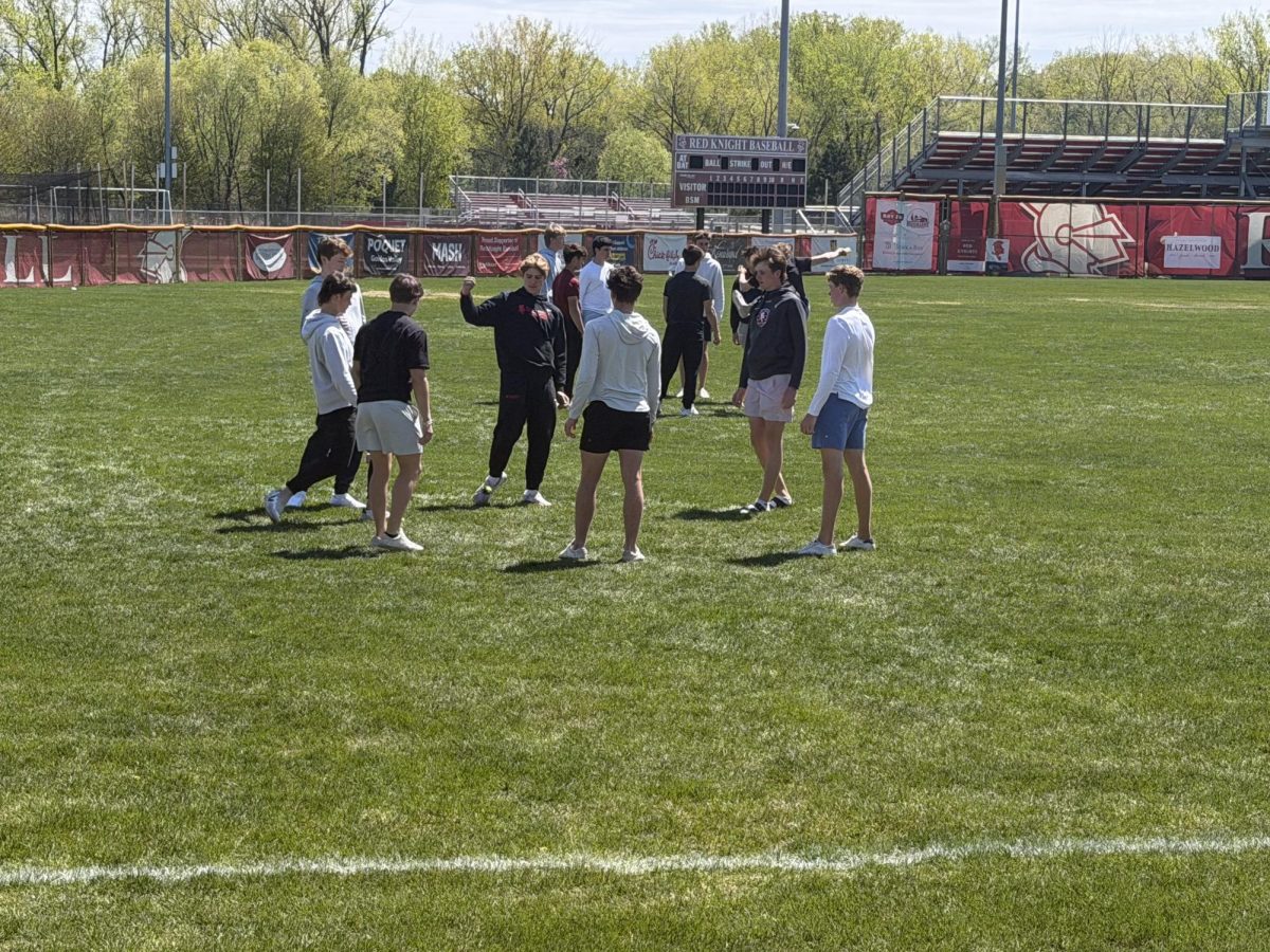 Students get outside in the warm weather to play hacky sack during lunch.